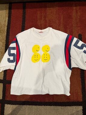 Kapital White Tee with Yellow Smiley Faces and Red-Blue Sleeve Stripes